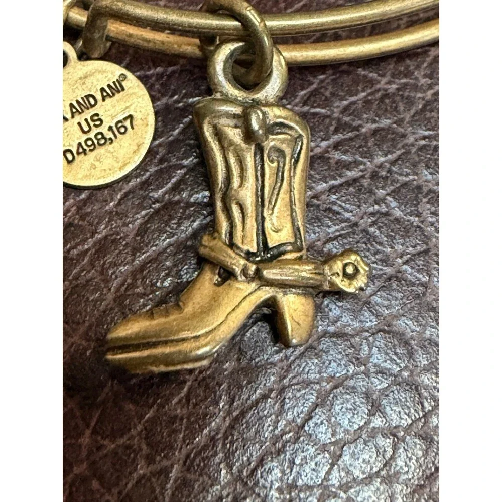 Alex and Ani Cowboy Boot charm bracelet featuring a gold-toned expandable bangle